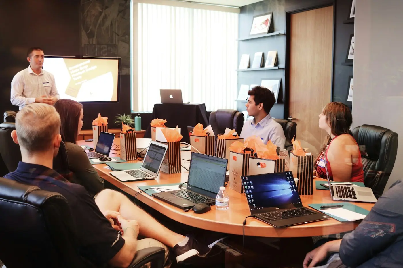 People seated along a conference table during a meeting.
